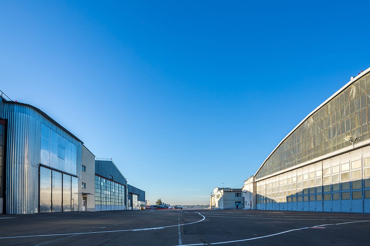 Large public-sector facility buildings under a clear blue sky, representing government and municipal projects