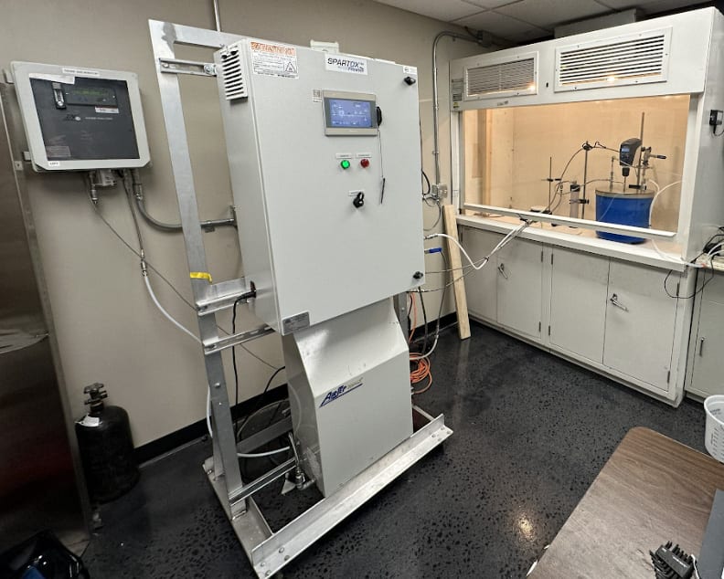 PRM SPARTOX bench-scale ozone pilot setup with control panel and fume hood in the lab
