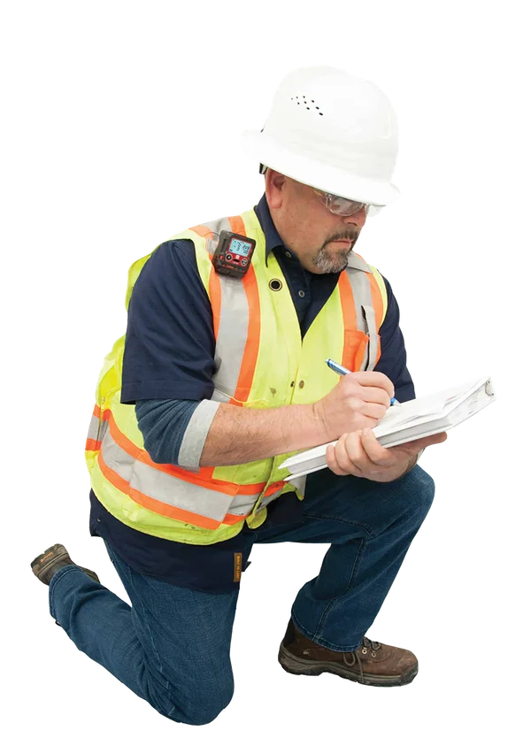 PRM field inspector in hi-vis PPE taking notes on a clipboard